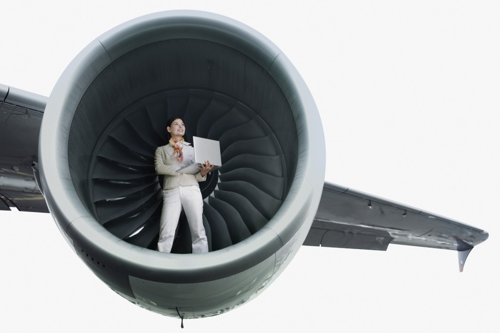 Businesswoman standing in airplane engine